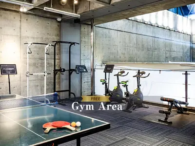 a gym with a ping pong table and some exercise bikes at Hotel Balian Resort Shinjuku Honten in Tokyo