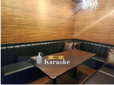 a table in a restaurant with a free karaoke sign on it at Hotel Balian Resort Shinjuku Honten in Tokyo