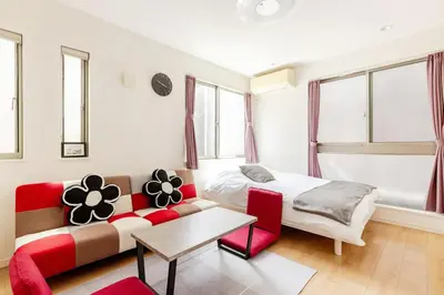 a living room with a couch and a bed at Ishihara House in Tokyo