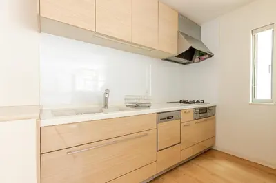 a kitchen with wooden cabinets and a sink at Ishihara House in Tokyo