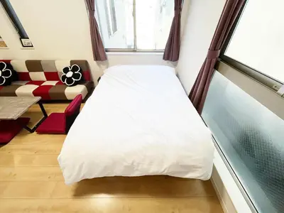 a bed in a room with a window at Ishihara House in Tokyo