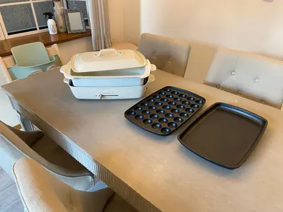 a desk with a keyboard and a suitcase on it at 4 bedrooms cozy house, 5 min JR train to Shinjuku, GRADIA Koenji in Tokyo