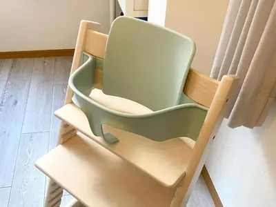 a green chair sitting in a room at 4 bedrooms cozy house, 5 min JR train to Shinjuku, GRADIA Koenji in Tokyo