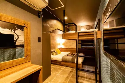 a small room with a bed and a bunk bed at UNDER RAILWAY HOTEL AKIHABARA in Tokyo
