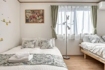 a bedroom with two beds and a window at Ikebukuro Station 7 minutes by walk 110 sqm villa in Tokyo