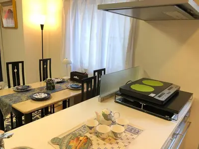 a kitchen with a table with two chairs and a stove at Ikebukuro Station 7 minutes by walk 110 sqm villa in Tokyo