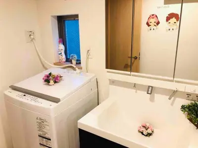 a bathroom with a washing machine and a sink at Ikebukuro Station 7 minutes by walk 110 sqm villa in Tokyo