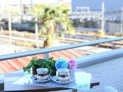 a table with two cups and flowers on a balcony at Ikebukuro Station 7 minutes by walk 110 sqm villa in Tokyo