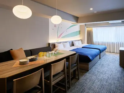 a hotel room with a bed and a dining room at Minn Ueno Iriya in Tokyo