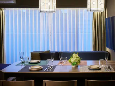 a dining room table with glasses and plates on it at Minn Ueno Iriya in Tokyo