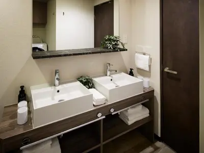 a bathroom with two sinks and a mirror at Minn Ueno Iriya in Tokyo