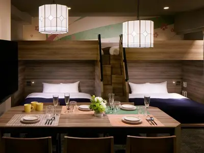 a dining room with a table and two beds at Minn Ueno Iriya in Tokyo