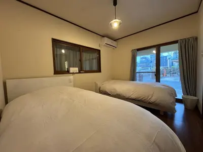a bedroom with two beds and a window at LEMON TOKYO in Tokyo