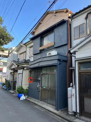 a blue building on the side of a street at Cozy house \u845b\u98fe in Tokyo