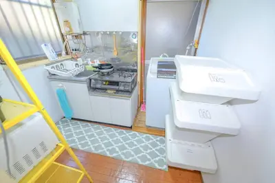 a small kitchen with a sink and a stove at Cozy house \u845b\u98fe in Tokyo