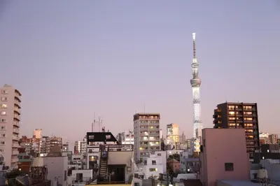 a city skyline with tall buildings and a tv tower at Yoshitsuki kaku - Yoshitsuki Apart Hotel in Tokyo