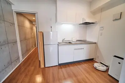 a small kitchen with a sink and a refrigerator at Yoshitsuki kaku - Yoshitsuki Apart Hotel in Tokyo