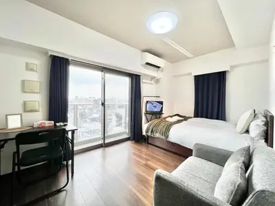 a bedroom with a bed and a desk and a couch at Otsuka No3 Mansion#JR Yamanote Line Otsuka in Tokyo
