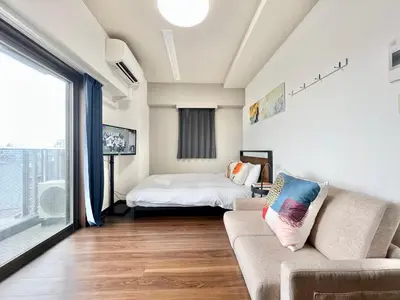 a living room with a couch and a bed at Otsuka No3 Mansion#JR Yamanote Line Otsuka in Tokyo