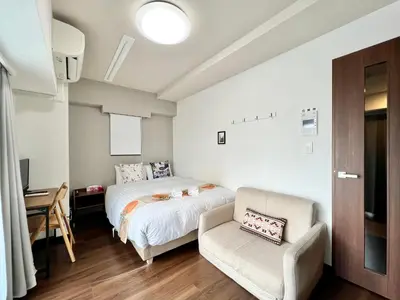 a bedroom with a bed and a chair at Otsuka No3 Mansion#JR Yamanote Line Otsuka in Tokyo