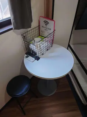 a small white table with a chair and a box on it at 043AKIHABARA in Tokyo