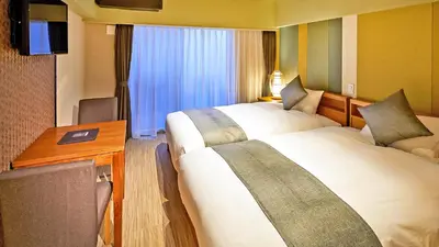 a hotel room with two beds and a desk at Stay SAKURA Tokyo Asakusa Yokozuna Hotel in Tokyo