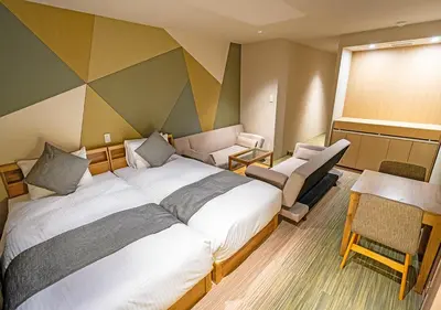 a hotel room with a large bed and a chair at Stay SAKURA Tokyo Asakusa Yokozuna Hotel in Tokyo