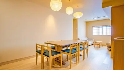 a dining room with a wooden table and chairs at Stay SAKURA Tokyo Asakusa Yokozuna Hotel in Tokyo