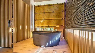 a large tub in a room with wooden walls at Stay SAKURA Tokyo Asakusa Yokozuna Hotel in Tokyo