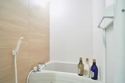 a bathroom with bottles on the back of a toilet at Beautiful Villa in Shinjuku Shin-OKubo 6minutes walk B in Tokyo