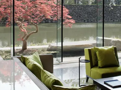 a room with a couch and a table and a window at Palace Hotel Tokyo in Tokyo