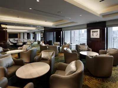 a hotel lobby with couches and tables and chairs at Palace Hotel Tokyo in Tokyo