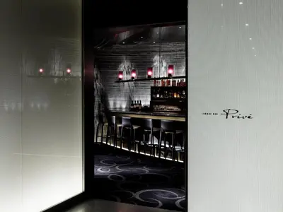 a bar with black stools in a room at Palace Hotel Tokyo in Tokyo