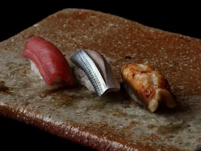 three different types of sushi on top of a table at Palace Hotel Tokyo in Tokyo