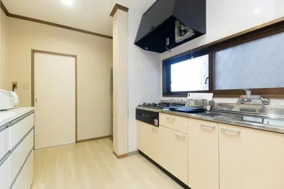 a kitchen with a stove and a sink and a window at STATION SIDE113 in Tokyo