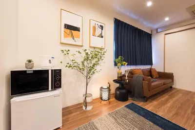 a living room with a couch and a television at TORA HOTEL Tokyo Skytree \u5bc5\u30db\u30c6\u30eb \u30b9\u30ab\u30a4\u30c4\u30ea\u30fcG in Tokyo