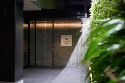 a door to a building with a sign on it at Hotel Resol Ueno in Tokyo