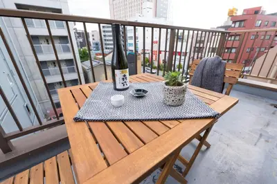 a bottle of wine sitting on a table on a balcony at TORA HOTEL Tokyo Skytree \u5bc5\u30db\u30c6\u30eb \u30b9\u30ab\u30a4\u30c4\u30ea\u30fcE in Tokyo