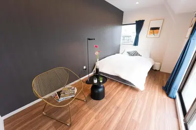 a small bedroom with a bed and a chair at TORA HOTEL Tokyo Skytree \u5bc5\u30db\u30c6\u30eb \u30b9\u30ab\u30a4\u30c4\u30ea\u30fcE in Tokyo