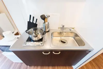 a kitchen counter with a sink and utensils at TORA HOTEL Tokyo Skytree \u5bc5\u30db\u30c6\u30eb \u30b9\u30ab\u30a4\u30c4\u30ea\u30fcE in Tokyo
