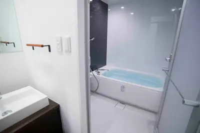 a bathroom with a bath tub and a sink at Shinjuku Miyabi Residence in Tokyo