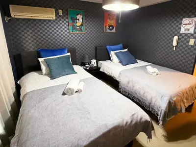 two beds in a room with blue and white at Asakusa Japanese Style Stay with Futon & Beds in Tokyo