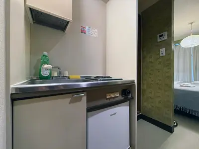 a kitchen with a sink in a room with a bed at Asakusa Japanese Style Stay with Futon & Beds in Tokyo