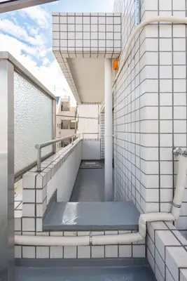 a balcony with a bench in a building at TORA HOTEL Tokyo-Rikugienn \u5bc5\u30db\u30c6\u30eb \u516d\u7fa9\u5712 D in Tokyo