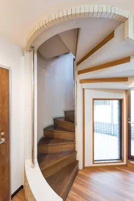 a spiral staircase in a house with a window at TORA HOTEL Tokyo-Rikugienn \u5bc5\u30db\u30c6\u30eb \u516d\u7fa9\u5712 D in Tokyo