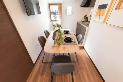 a small dining room with a table and chairs at TORA HOTEL Tokyo-Rikugienn \u5bc5\u30db\u30c6\u30eb \u516d\u7fa9\u5712 D in Tokyo