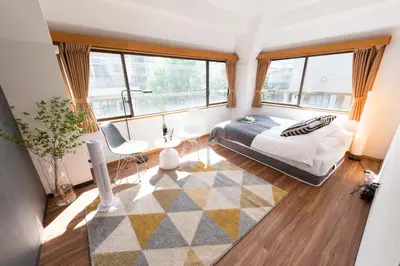 a bedroom with a bed and a large window at TORA HOTEL Tokyo-Rikugienn \u5bc5\u30db\u30c6\u30eb \u516d\u7fa9\u5712 D in Tokyo