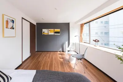a bedroom with a bed and a desk and a window at TORA HOTEL Tokyo-Rikugienn \u5bc5\u30db\u30c6\u30eb \u516d\u7fa9\u5712 C in Tokyo