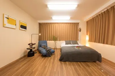 a hotel room with a bed and a chair at TORA HOTEL Tokyo-Rikugienn \u5bc5\u30db\u30c6\u30eb \u516d\u7fa9\u5712 B in Tokyo