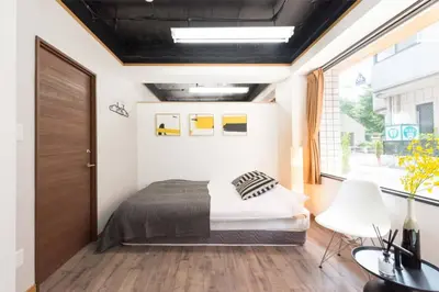 a bedroom with a bed and a large window at TORA HOTEL Tokyo-Rikugienn \u5bc5\u30db\u30c6\u30eb \u516d\u7fa9\u5712 A in Tokyo